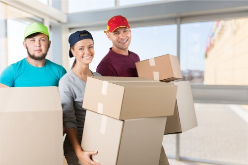 Professional movers handling office furniture and boxes in a South Kensington workspace