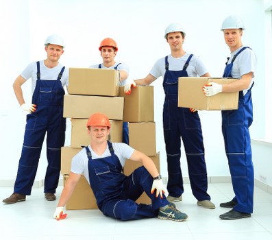 Removal team handling desks and files in a local office relocation