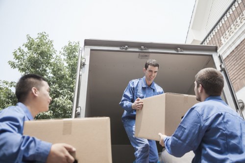 Loading household furniture into a moving truck in central London