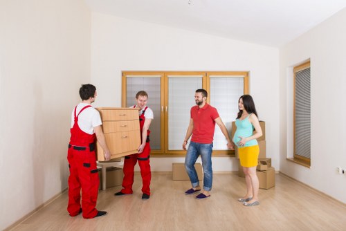 Careful piano moving through a narrow stairway in a South Kensington property